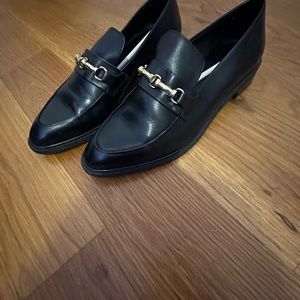 Buckled black leather loafers